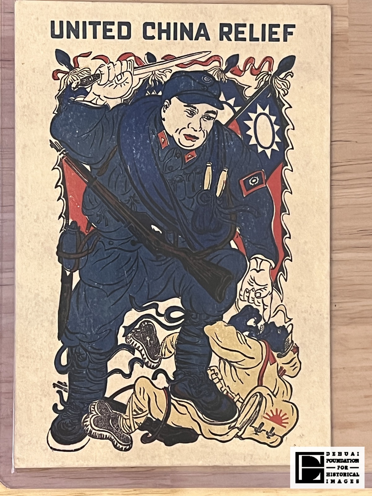 TFA-CA-124 — Face of the sheet: the soldier with raised sword and slung rifle before blue fields bearing white rayed suns, his boot on a fallen soldier, with a rounded form beside the fallen man marked with a red rising sun.